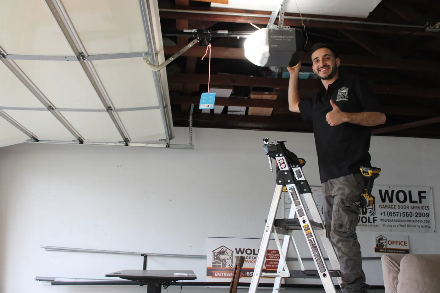 Wolf technician giving a thumbs up after a garage door opener repair